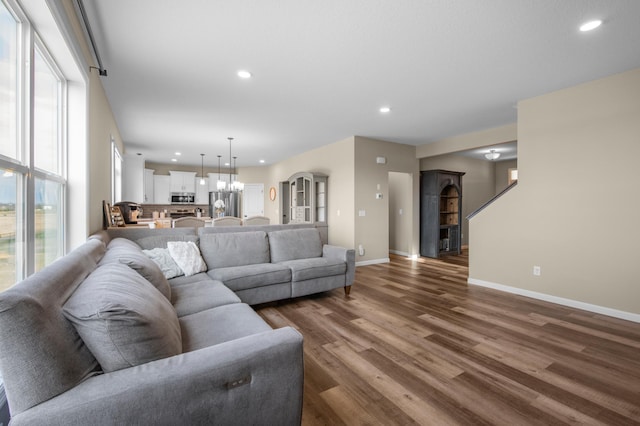 living room featuring dark hardwood / wood-style flooring and a notable chandelier