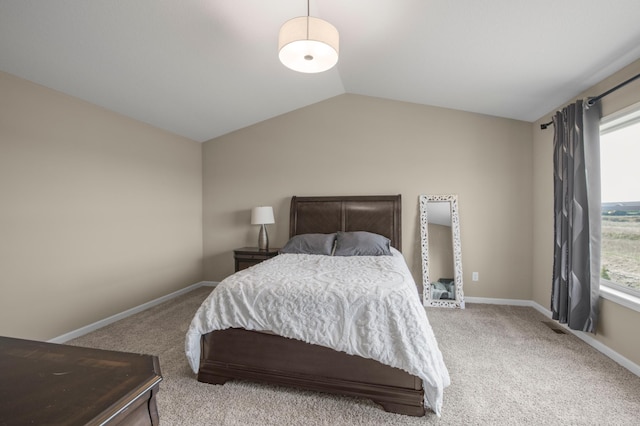 carpeted bedroom with vaulted ceiling