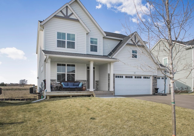 view of front facade featuring a garage, central AC, a front yard, and a porch