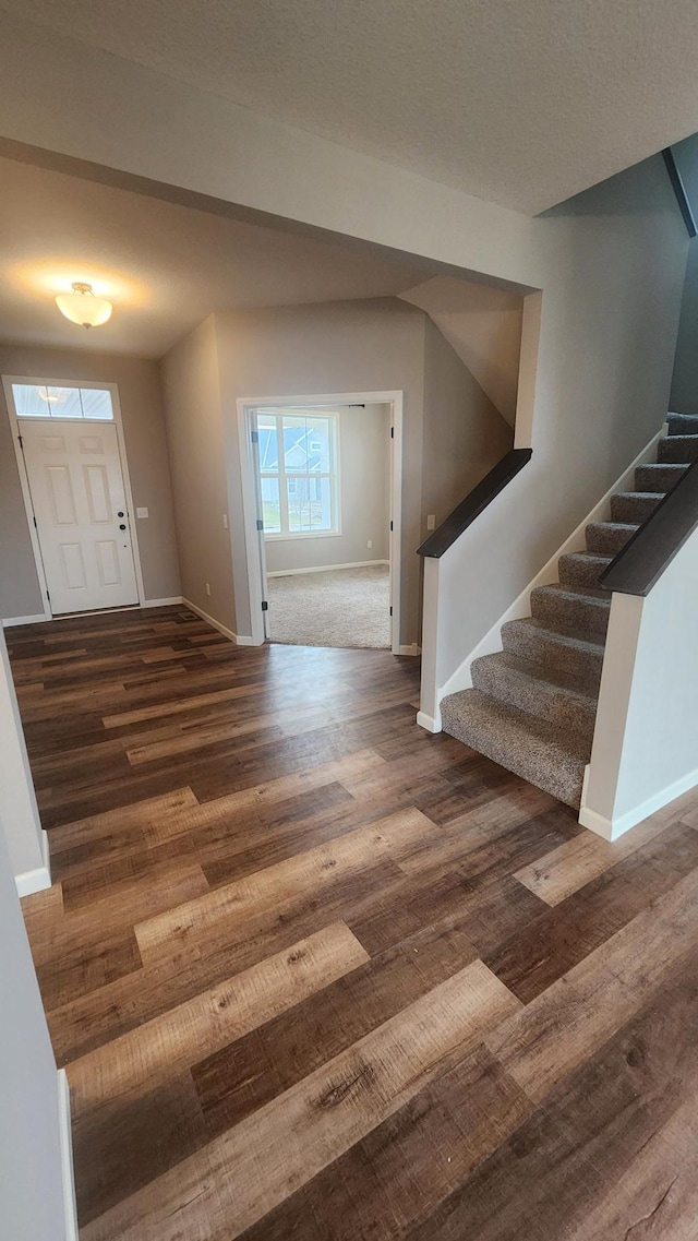 foyer entrance with dark hardwood / wood-style floors