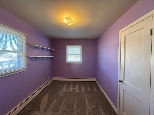 carpeted spare room featuring baseboard heating and baseboards
