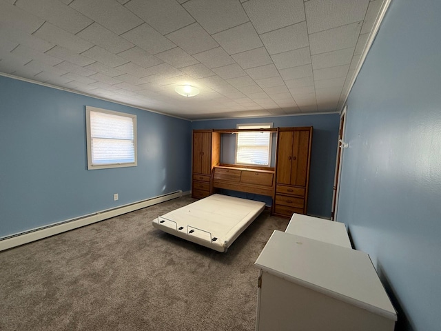 bedroom with a baseboard heating unit, dark carpet, and baseboards