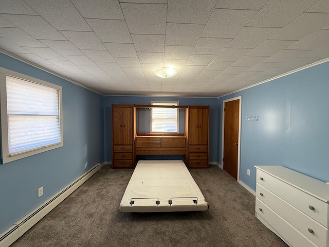 unfurnished bedroom featuring dark carpet, a baseboard radiator, baseboards, and ornamental molding