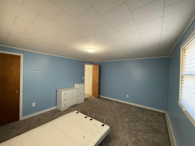 unfurnished bedroom with a baseboard radiator, carpet floors, ornamental molding, and baseboards