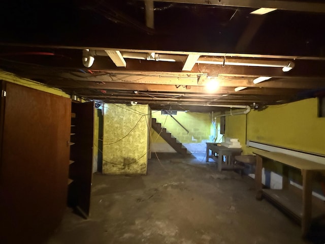unfinished below grade area featuring stairs