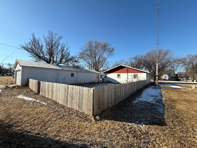 view of side of home with fence
