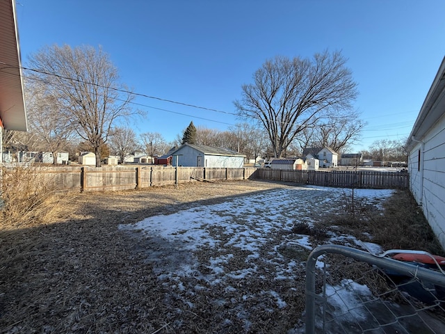 yard covered in snow featuring a fenced backyard