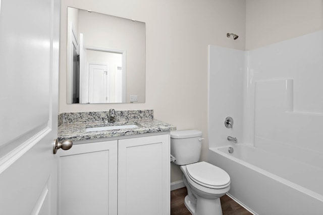 full bathroom featuring vanity, hardwood / wood-style flooring, bathing tub / shower combination, and toilet