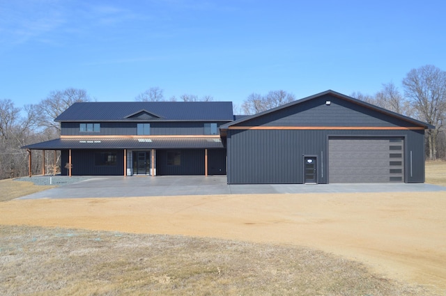 view of front of property featuring a garage and dirt driveway