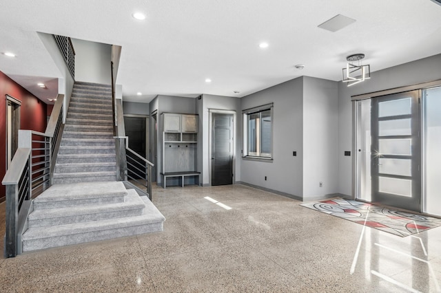 foyer entrance featuring baseboards, stairs, and recessed lighting