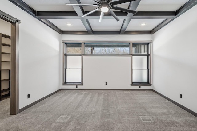 carpeted empty room with baseboards, ceiling fan, coffered ceiling, and beam ceiling