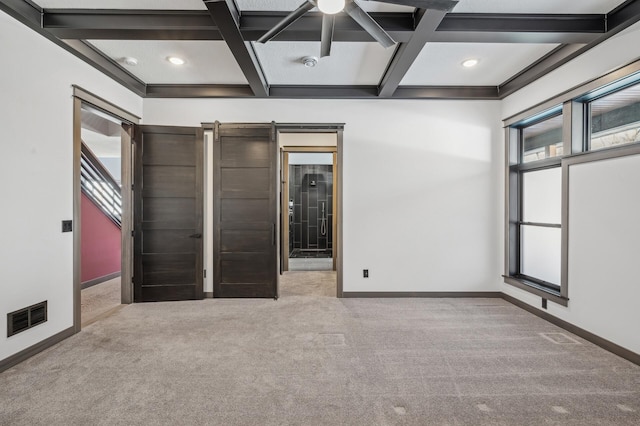 empty room with carpet, baseboards, and visible vents