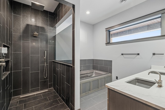 bathroom with a sink, a garden tub, tile patterned flooring, and tiled shower