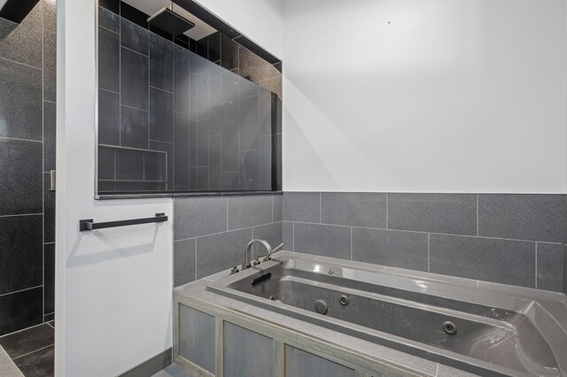 full bathroom with a whirlpool tub