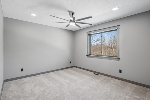 carpeted spare room with recessed lighting, baseboards, a textured ceiling, visible vents, and ceiling fan