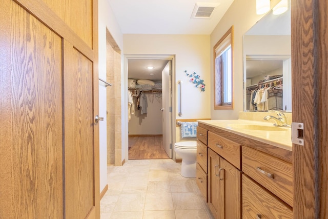 bathroom featuring toilet and vanity