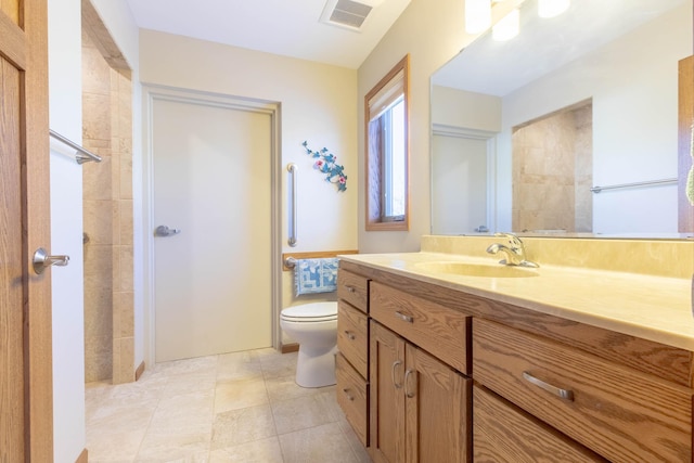 bathroom featuring toilet and vanity