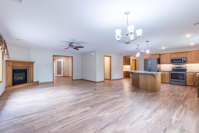 932 Oak Pond Ct, Sartell, MN 56377 - kitchen with stainless steel appliances, open floor plan, a breakfast bar area, light countertops, and a kitchen island