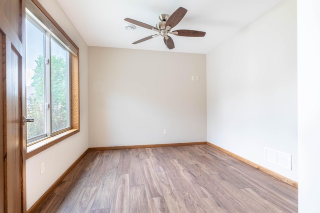 932 Oak Pond Ct, Sartell, MN 56377 - empty room with plenty of natural light, light wood-style floors, and baseboards