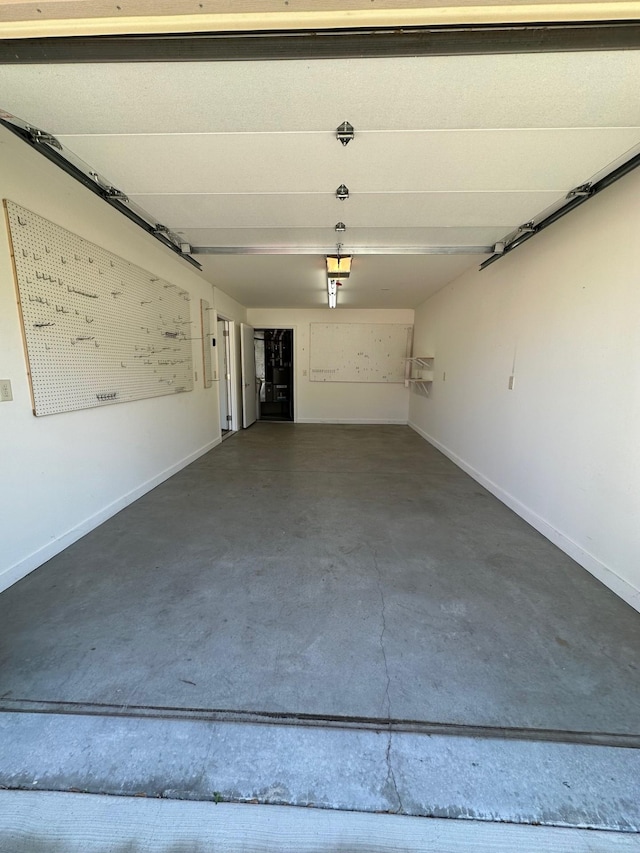 932 Oak Pond Ct, Sartell, MN 56377 - garage with baseboards and a garage door opener
