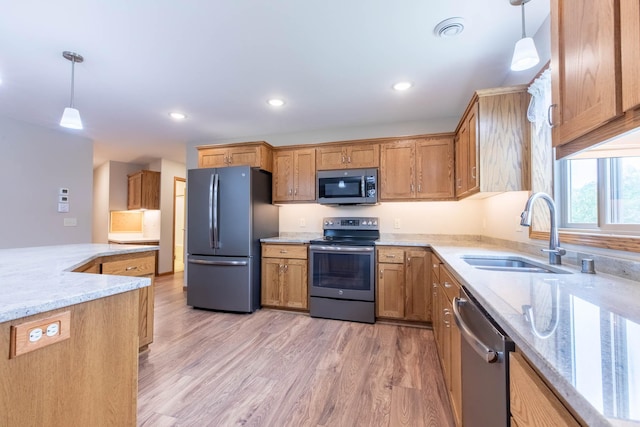 932 Oak Pond Ct, Sartell, MN 56377 - kitchen featuring appliances with stainless steel finishes, a sink, light wood-type flooring, decorative light fixtures, and recessed lighting