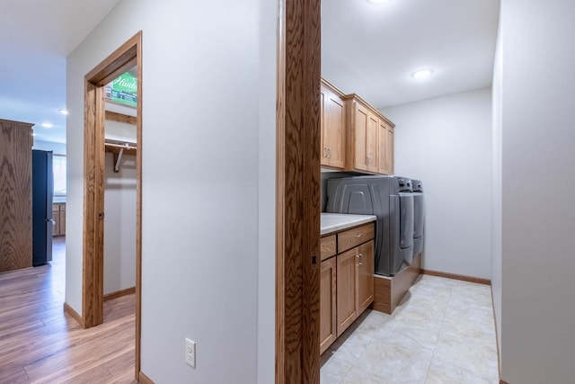 932 Oak Pond Ct, Sartell, MN 56377 - washroom with separate washer and dryer, cabinet space, baseboards, and light wood-style flooring