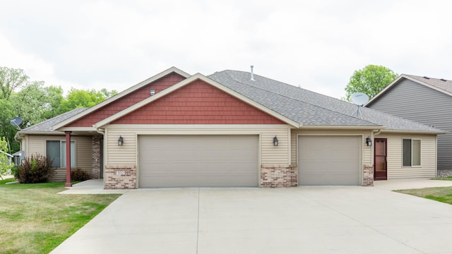 932 Oak Pond Ct, Sartell, MN 56377 - craftsman-style house featuring an attached garage, driveway, brick siding, a front lawn, and roof with shingles