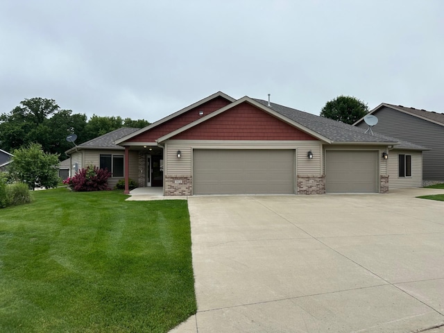 932 Oak Pond Ct, Sartell, MN 56377 - craftsman-style house featuring a garage, driveway, a front yard, and brick siding