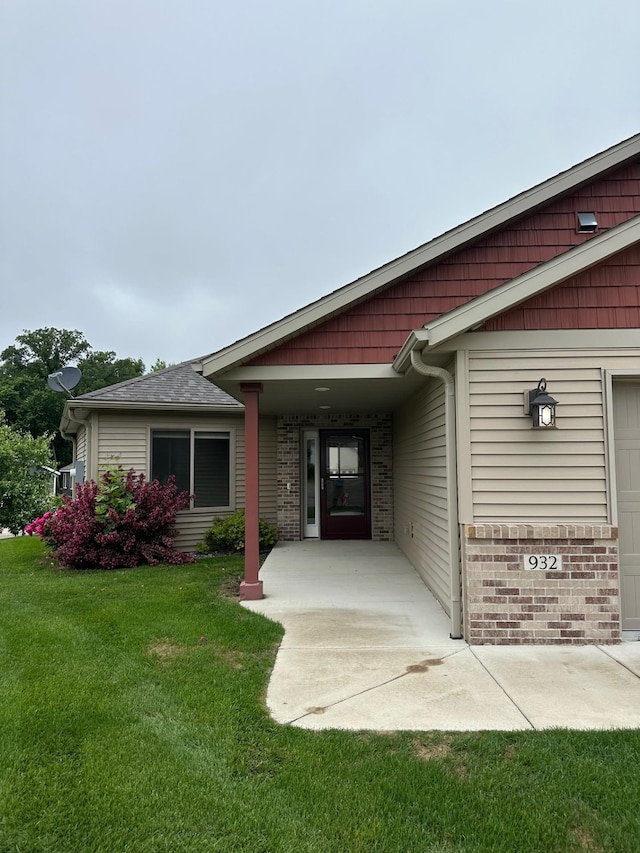 932 Oak Pond Ct, Sartell, MN 56377 - property entrance featuring a yard, brick siding, and an attached garage