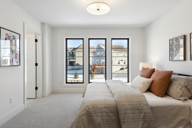 bedroom featuring light colored carpet and access to exterior