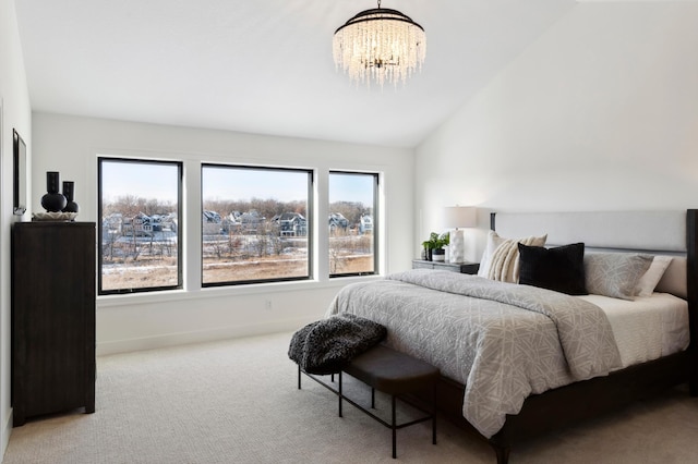 carpeted bedroom with lofted ceiling and an inviting chandelier