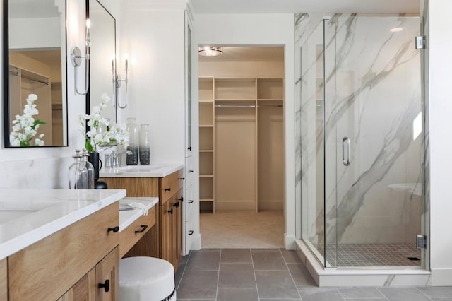 bathroom featuring vanity, tile patterned floors, and a shower with shower door