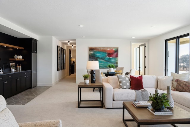 living room with light carpet and indoor wet bar