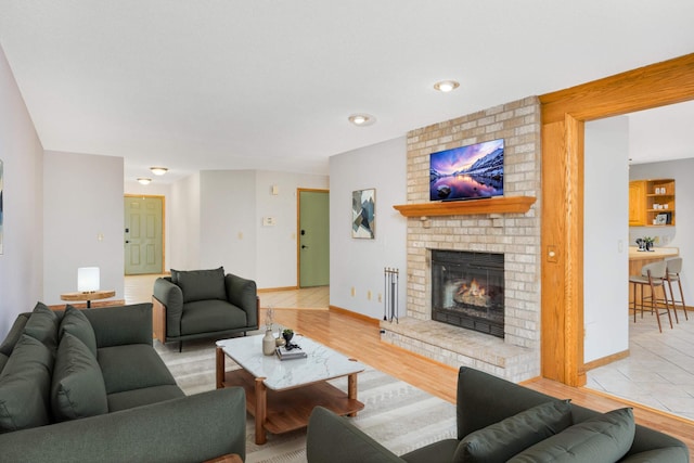 living room featuring a fireplace and light hardwood / wood-style flooring