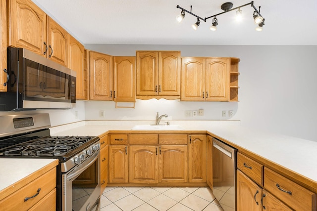 kitchen with stainless steel appliances, sink, and light tile patterned floors