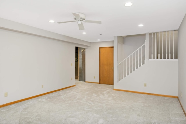 unfurnished room with ceiling fan and light carpet