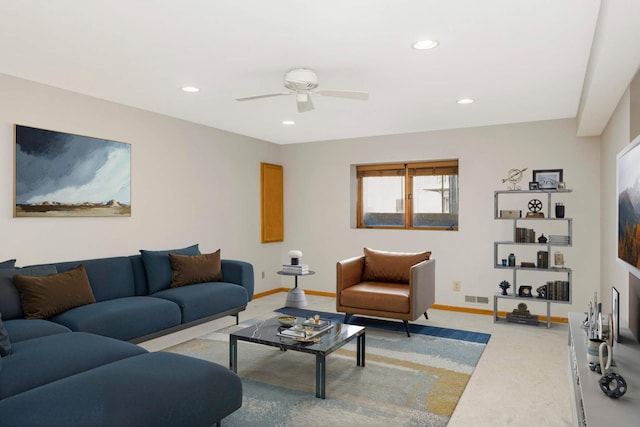 carpeted living room with ceiling fan