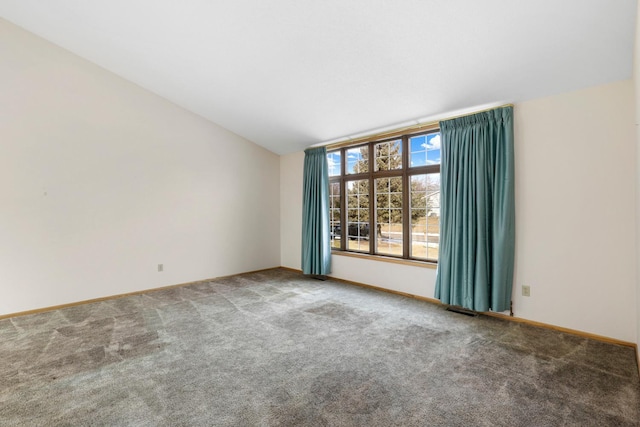 carpeted empty room with lofted ceiling