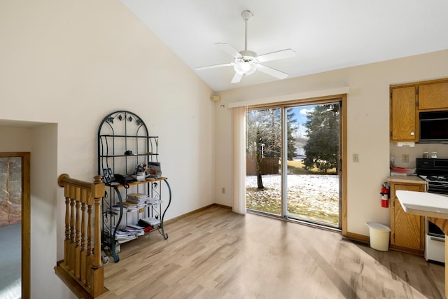 entryway featuring lofted ceiling, light hardwood / wood-style flooring, and ceiling fan