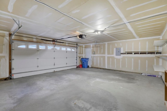 garage featuring a garage door opener and electric panel