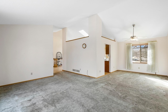 unfurnished living room with high vaulted ceiling, light colored carpet, and ceiling fan