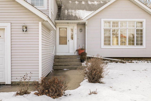 view of snow covered property entrance