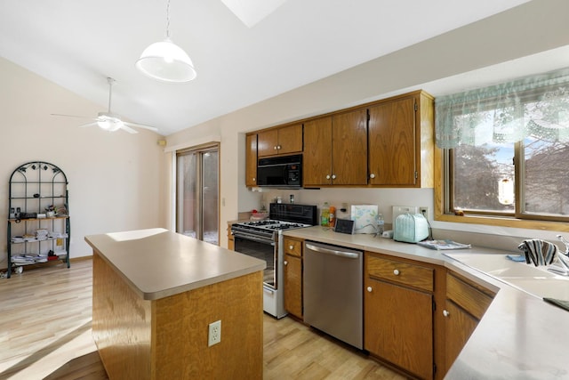 kitchen with pendant lighting, white range with gas stovetop, dishwasher, a kitchen island, and vaulted ceiling