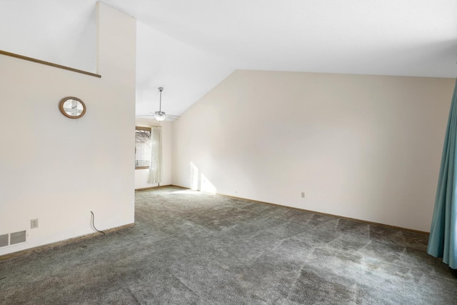 spare room featuring lofted ceiling, ceiling fan, and carpet flooring