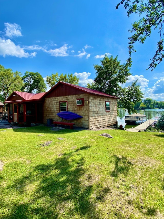 view of property exterior featuring a lawn and a water view