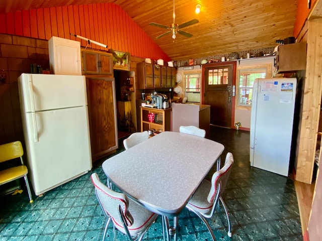 kitchen featuring white refrigerator, lofted ceiling, wooden ceiling, and ceiling fan