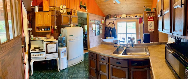 kitchen featuring lofted ceiling, sink, white fridge, ceiling fan, and wooden ceiling
