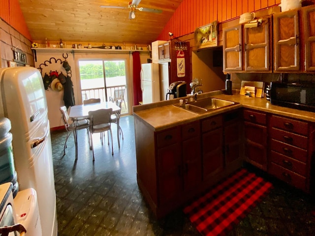 kitchen featuring vaulted ceiling, sink, white fridge, and wooden ceiling
