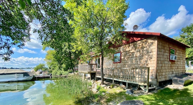 view of side of home featuring cooling unit and a deck