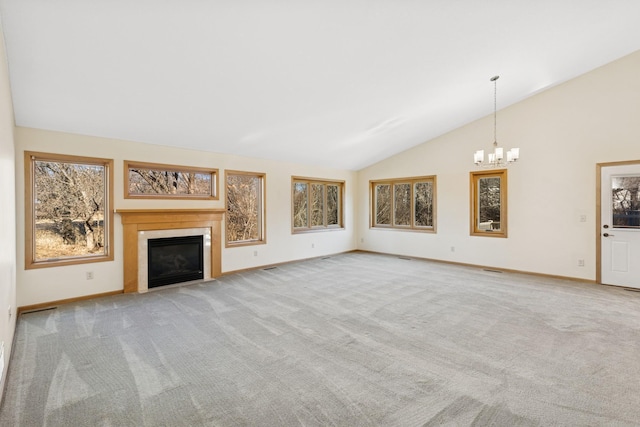 unfurnished living room with carpet, a fireplace with flush hearth, a chandelier, and baseboards